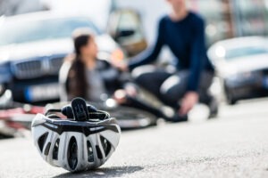 cyclist-and-helmet-on-the-ground-after-in-a-bicycle-car-accident