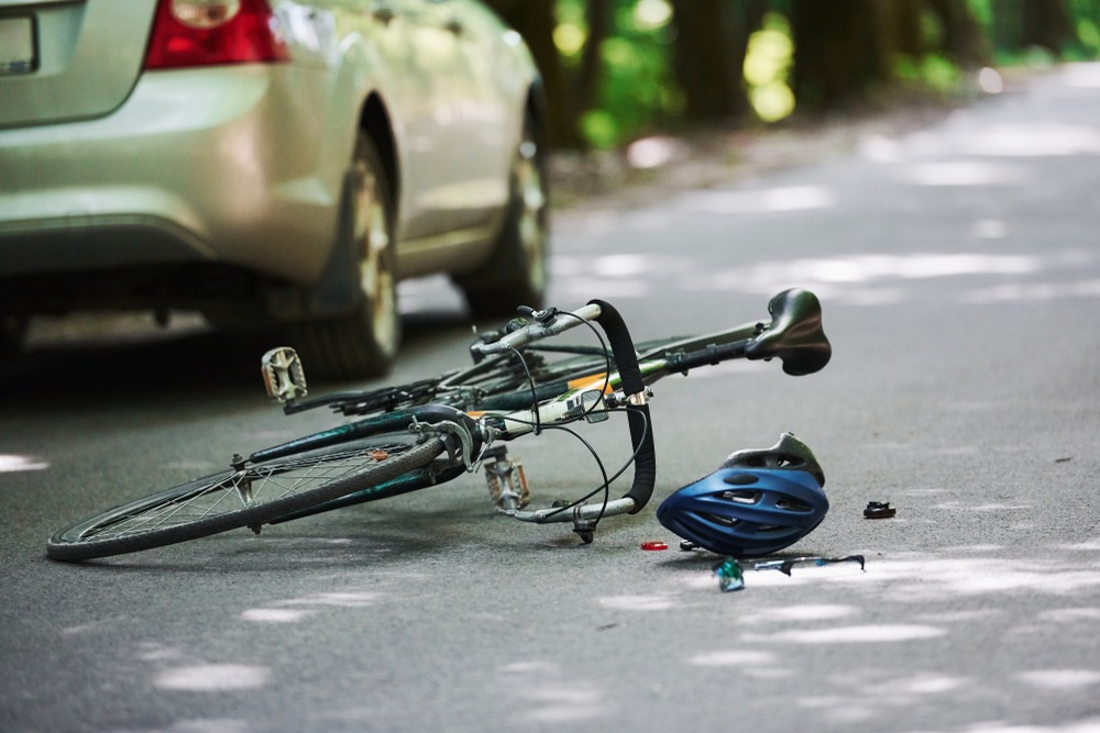 Bicycle hit by a car laying on the street in Indianapolis with helmet laying next to it