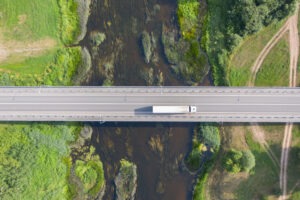 aerial-view-of-truck-driving-over-a-bridge