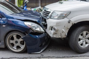 A pickup truck and car after a wreck. Our team provides information about what happens if you leave the scene of a pickup truck accident without exchanging details.