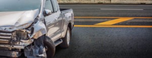 A pickup truck damaged after an accident. Find out if leaving the scene of a pickup truck accident with no one else involved is okay. 