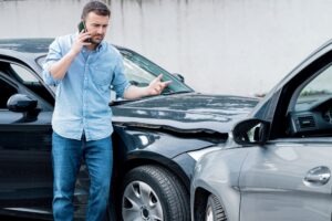 Man on the phone with a car accident lawyer in Shelbyville, Indiana, after a wreck.