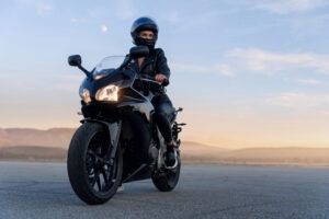 young-person-poses-with-motorcycle