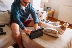 An injured man on a couch. Talk to a personal injury lawyer in Westfield, Indiana, if you sustained injuries in an accident.