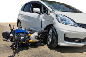 A car and motorcycle after a wreck. Work with our team to go over common mistakes to avoid when dealing with a motorcycle accident case.