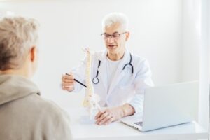 A doctor discussing a spinal cord. Determine if you can get damages with a spinal cord injury lawyer in Plainfield, Indiana