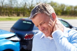 A man with a neck injury from a car accident. Go over the typical car accident settlement when you are injured. 