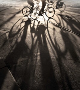 People biking in the city at dusk. You can turn to a Portage bicycle accident lawyer for help in the event of a crash.