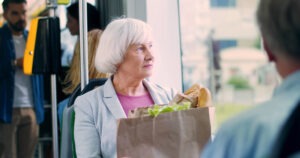 An older woman riding on a bus. You can contact a Valparaiso bus accident lawyer for help after a collision.