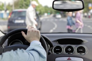 A driver watching pedestrians cross the road. After a collision, you can contact a Valparaiso pedestrian accident lawyer for help.