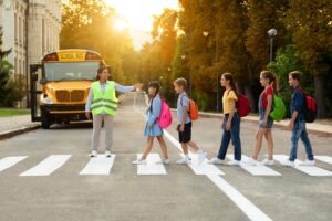 A group of children crossing the road. A lawyer can explain what to do if your child is hit by a rideshare driver.