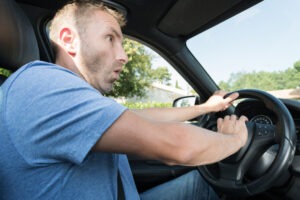 A man driving recklessly. You can talk to a lawyer about what to do if your Uber is a reckless driver.