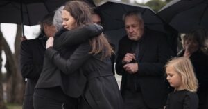 A family attends the funeral of a loved one and discusses who can file a wrongful death lawsuit.