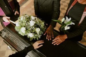 A family at a funeral. A lawyer can explain if you can sue if a family member dies.