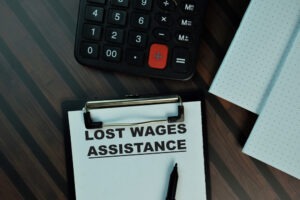 A clipboard holds lost wage assistance paperwork.