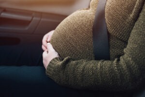 A woman sits in a car moments before a major crash. After the collision, she wonders what to do if the car accident causes her a miscarriage.