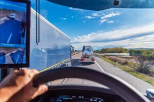 A truck overtakes two other trucks in what could be a dangerous maneuver. Truck driving can be dangerous.