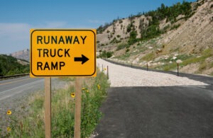 A runaway truck ramp and sign advising what a runaway truck is supposed to do.