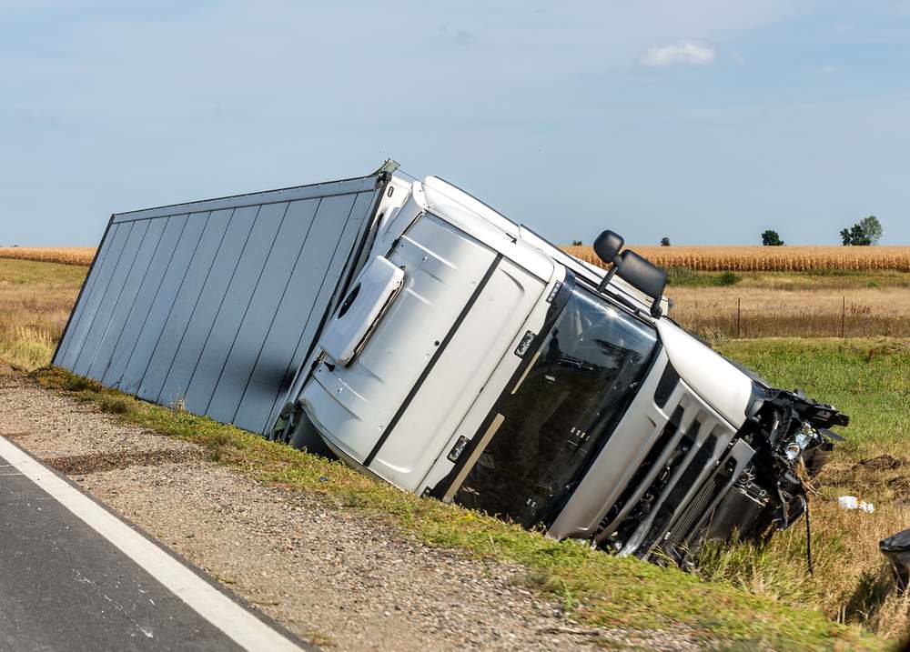 Overturned delivery truck in a ditch, similar to accidents where black box data helps prove Amazon truck accident evidence in Indiana